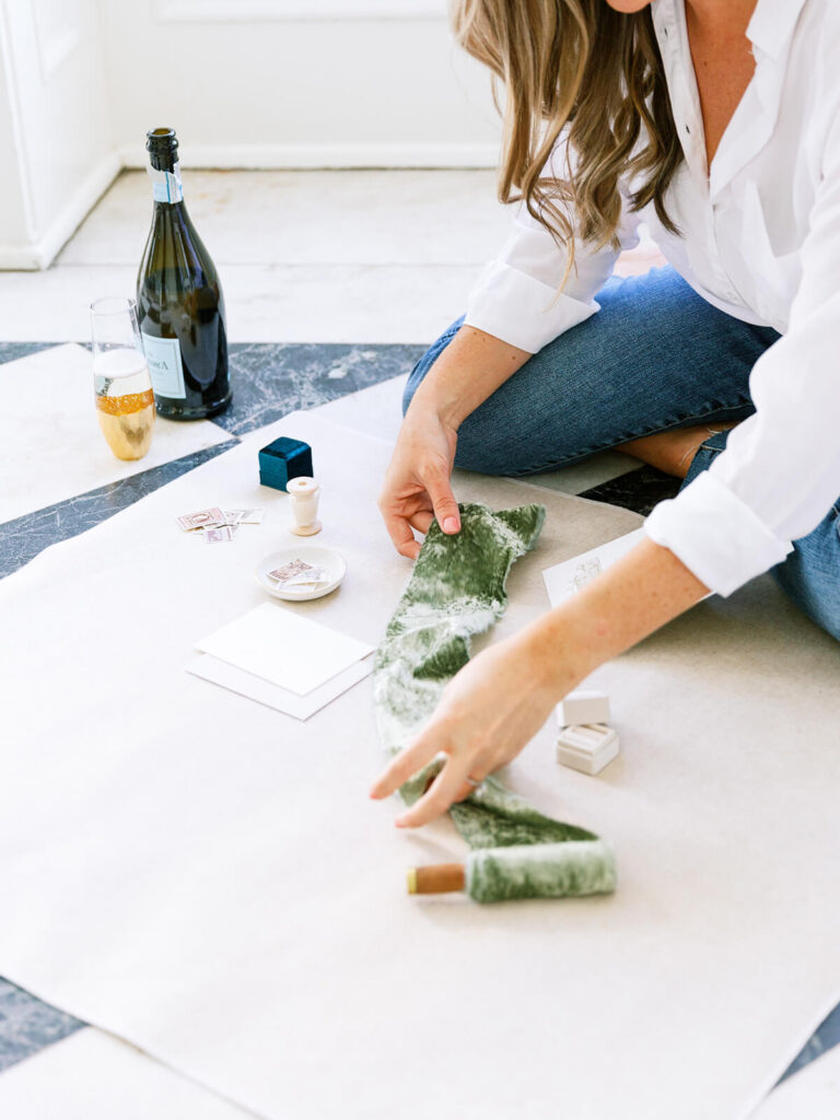 Wedding stationer styling a flat lay of an invitation