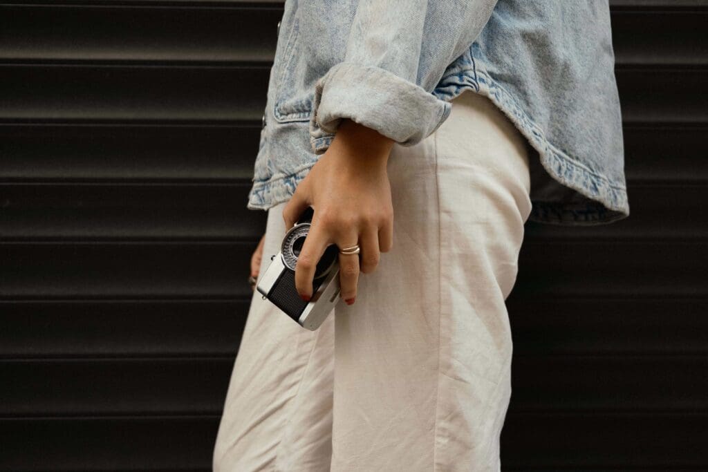 Stock photo of a woman carrying a film camera